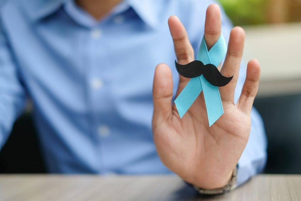 prostate cancer awareness man holding blue ribbon and moustache
