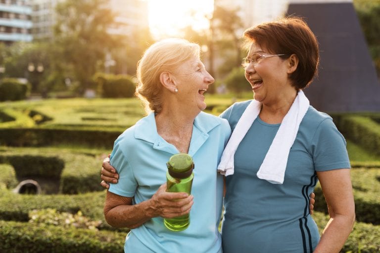 2 senior women exercising and laughing