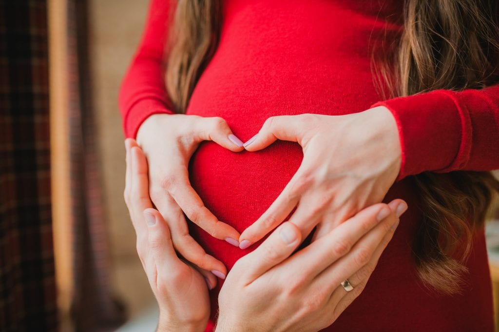 pregnant woman holding her belly