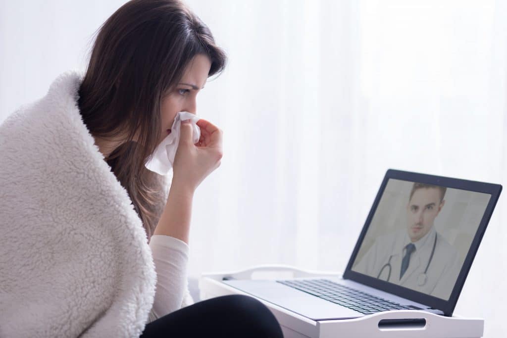 sick woman video calling doctor