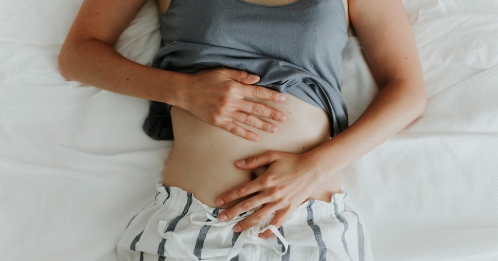 female clutching her stomach